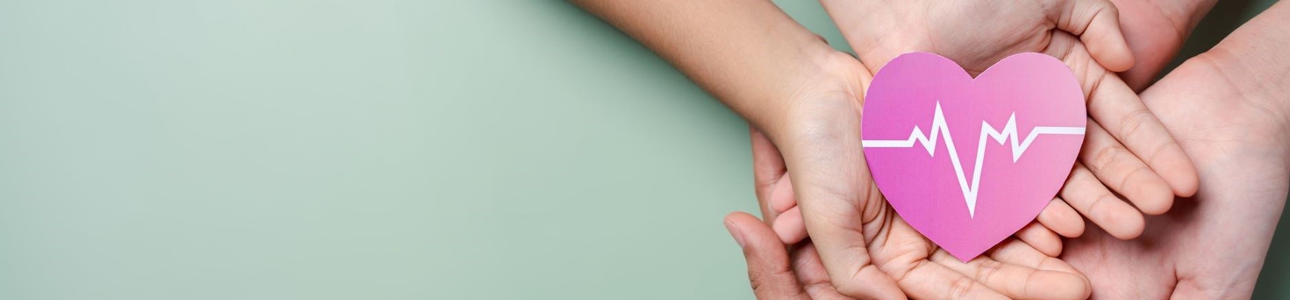 Hands holding a paper heart cutout